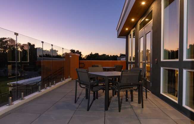 a terrace with a table and chairs on a balcony at Solasta, Sacramento, CA, 95831