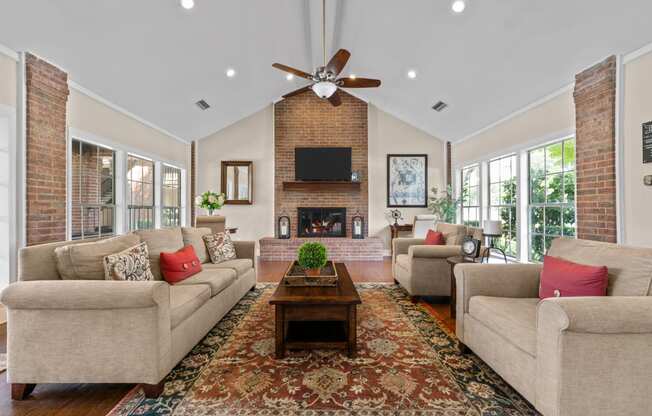 a living room with couches a coffee table and a fireplace