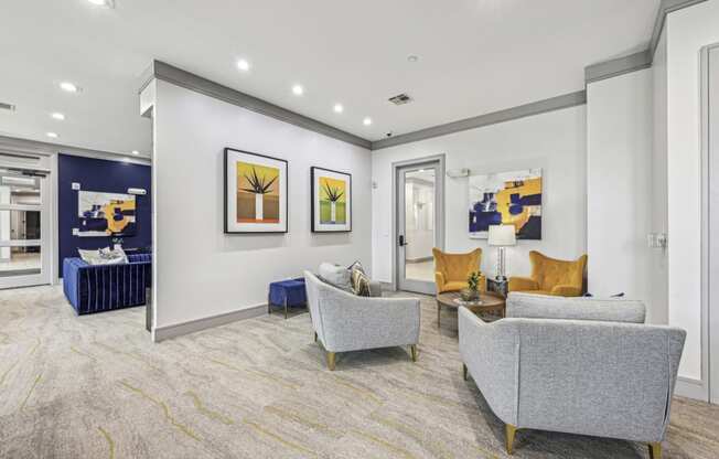 Clubroom with comfortable seating and contemporary artwork at Allusion at West University apartments in Houston, TX