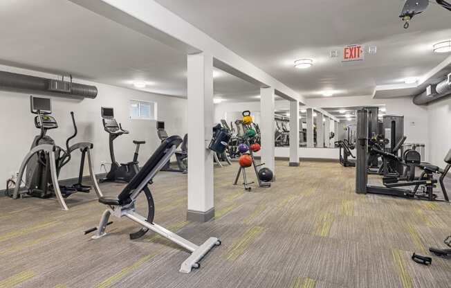 a gym with treadmills and other exercise equipment in a building
