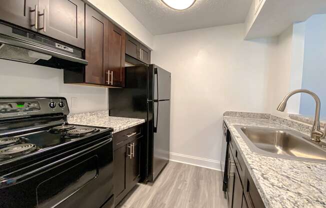 Spacious kitchen with wood style plank flooring at Camelot East Apartments, Fairfield, Ohio