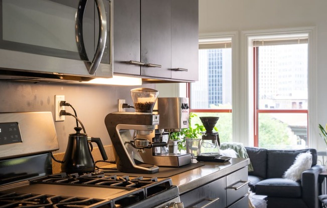 a kitchen with a stove and a coffee maker on the counter