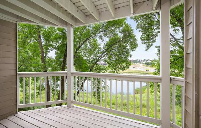 the view from the porch of a house overlooking a lake