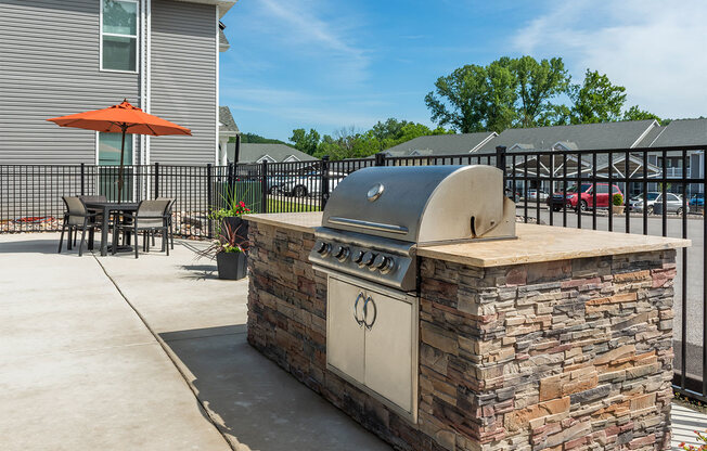 our outdoor kitchen has a grill and a pizza oven on our patio
