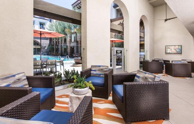 a patio with wicker furniture and a large window