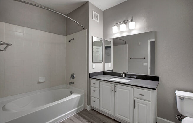 a bathroom with a bathtub and a sink