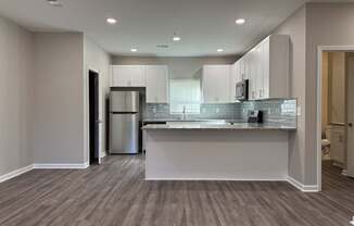 New 3 bedroom kitchen with a countertop and cabinets.