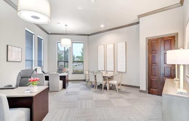 a living room and dining room with a table and chairs