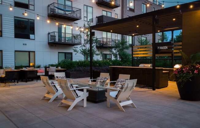 a patio with tables and chairs outside of a building
