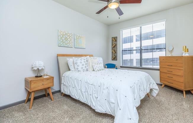 a bedroom with a bed and desk in a room