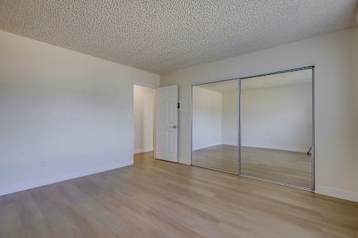 A room with a white door and a sliding glass door.