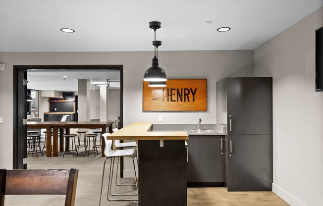 a kitchen and dining area with a table and chairs and a refrigerator