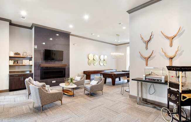 a living room with a billiards table and a dining room with couches