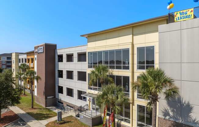 a large building with palm trees in front of it