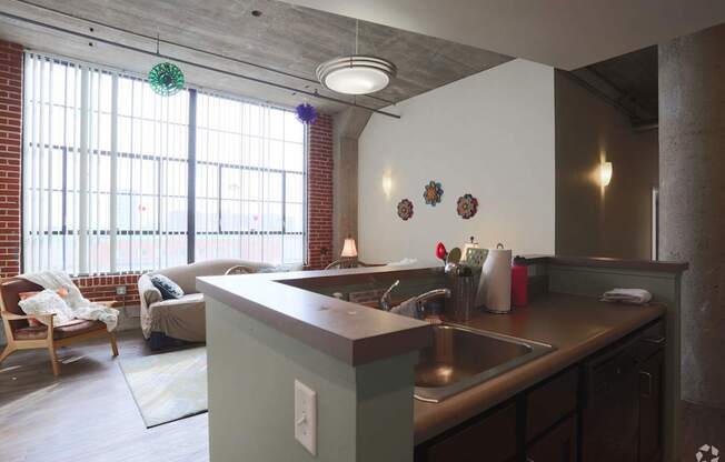 A kitchen with a sink and a window.