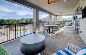 a large balcony with tables and chairs and a view of the city at The Jane at Preston Trail, Cedar Hill, TX, 75104