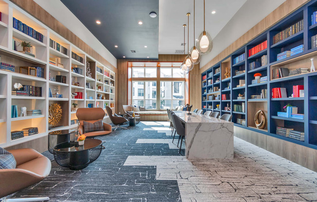 the lobby of a library with a long table and chairs