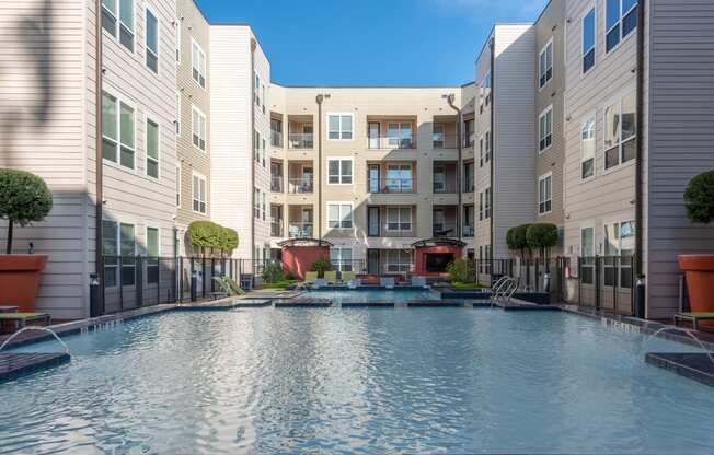 a swimming pool in front of an apartment building