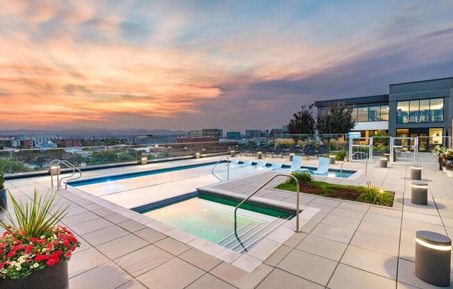 Rooftop pool and spa with sunset views over the city and mountains.