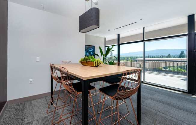 A dining room with a table and chairs.