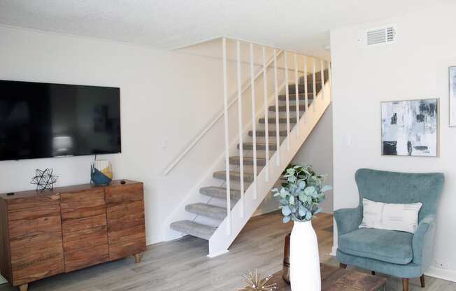 living room with hardwood style flooring and staircase leading upstairs  at Huntsville Landing Apartments, Alabama