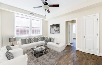 living area with sofa, coffee table, sitting area, hardwood flooring, and ceiling fan petworth station apartments in washington dc