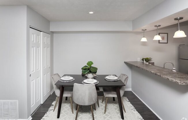 a dining room with a table and chairs