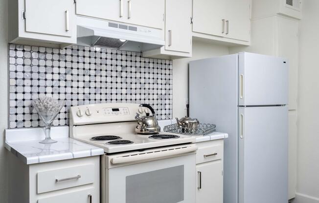 a stove top oven sitting inside of a kitchen