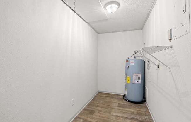 The Retreat at Indian Lake Apartments for rent in Hendersonville TN room with a grey water heater and wooden floor.