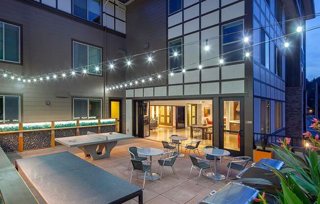 a patio with tables and chairs outside of a building