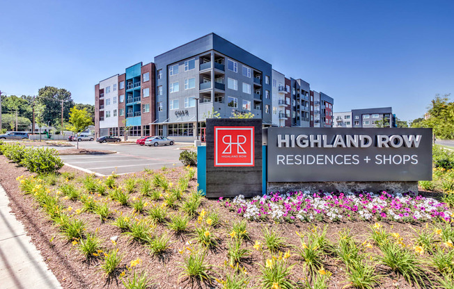 A sign for Highland Row Residences and Shops is in front of a building at Highland Row Apartments, Memphis, TN, 38111
