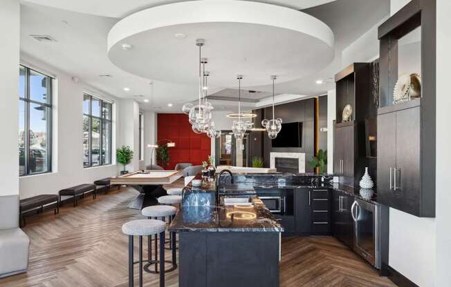 A modern kitchen with a bar area and a dining table.