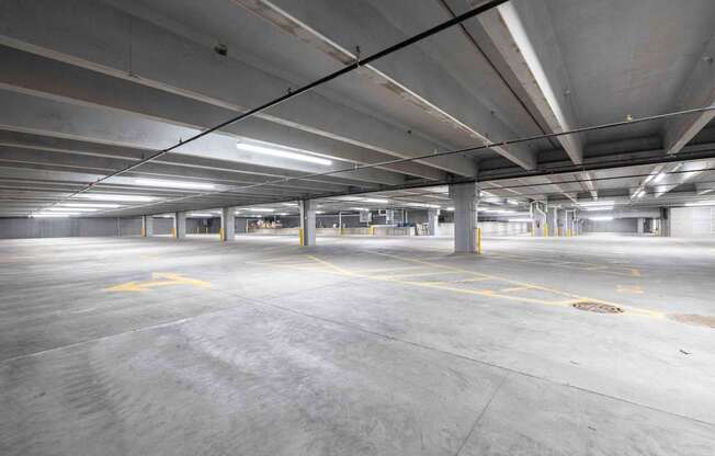 A large, empty parking garage with concrete floors and ceilings.