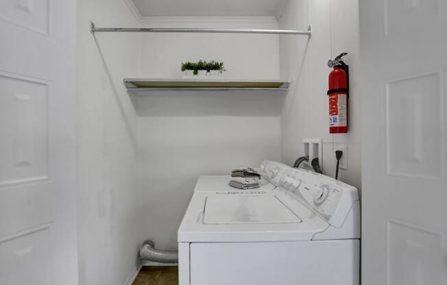 Apartments in Williamsport | Woodland Park |a small laundry room with a white washer and dryer