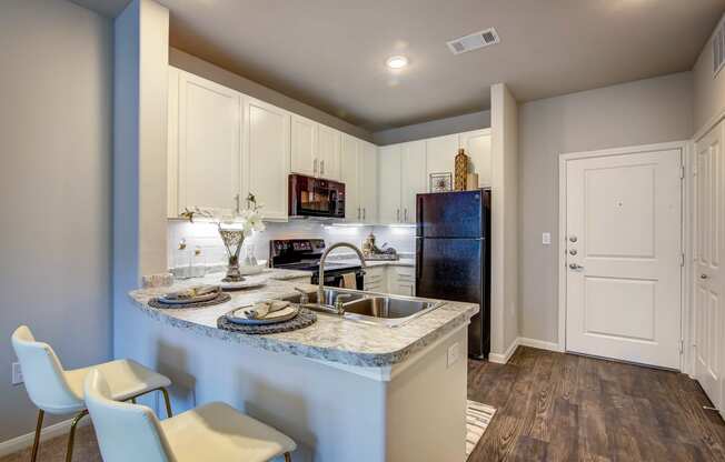 a kitchen with white cabinets and blue granite countertops