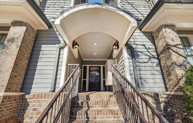 A house with a staircase leading to the front door.