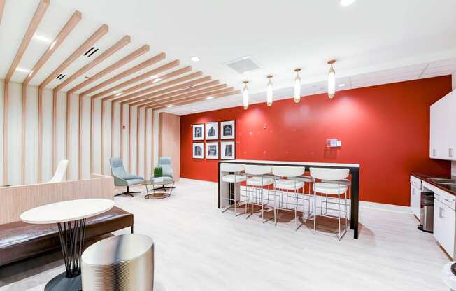 resident lounge with social seating, tables, and catering kitchen at archer park apartments in southeast Washington dc