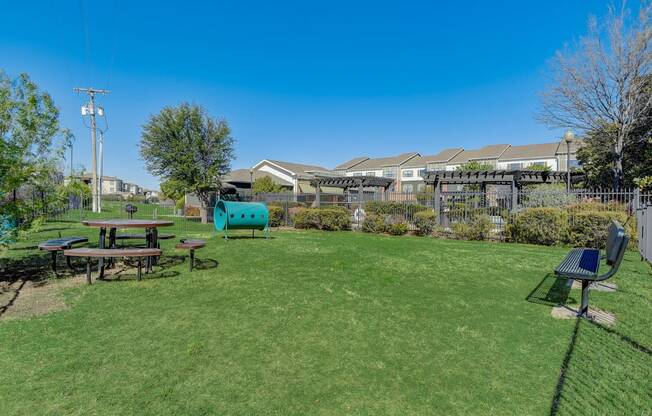 a backyard with a picnic table and a playground