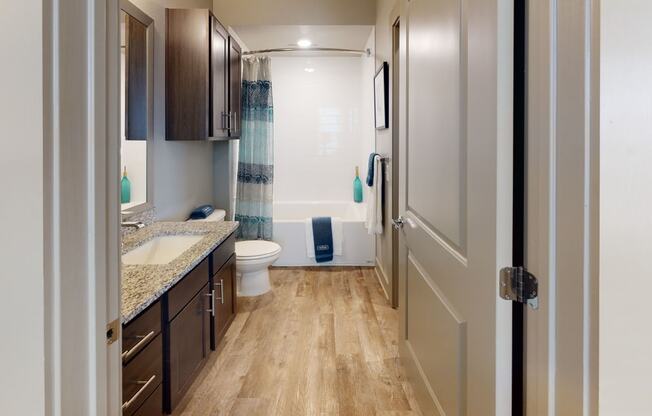 a bathroom with a toilet sink and bathtub in a 555 waverly unit