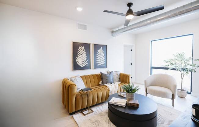 a living room with a brown couch and a coffee table