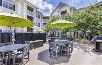 our yard with tables and chairs and umbrellas at our apartments on the strip