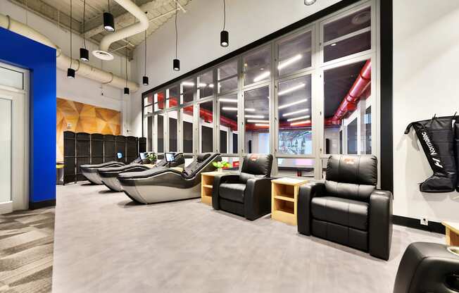 a large lobby with chairs and tables and large windows