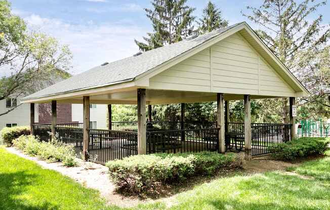 A small building with a black fence around it.