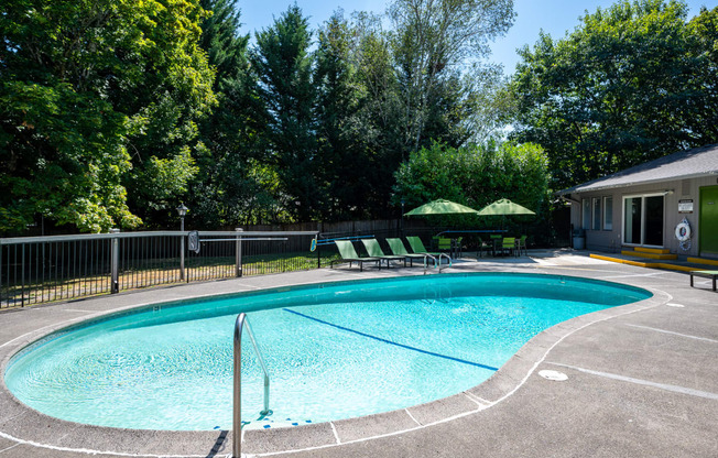 a resort style swimming pool in front of a house