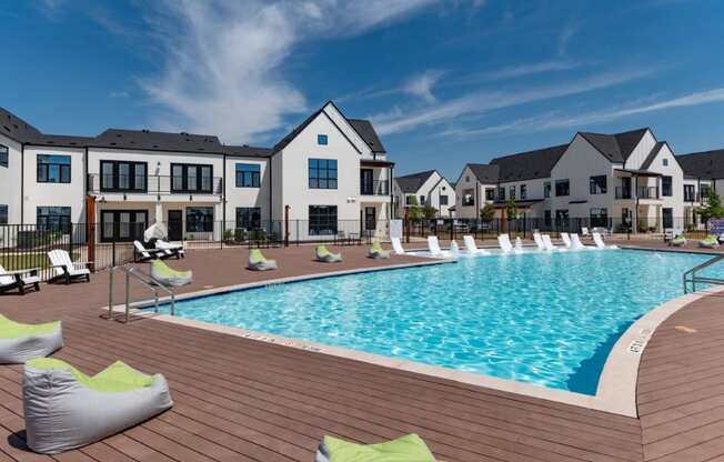 a large swimming pool in front of an apartment building