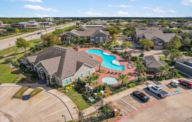 an aerial view of a neighborhood with a swimming pool and houses at Sladestone Shadow Creek, Texas