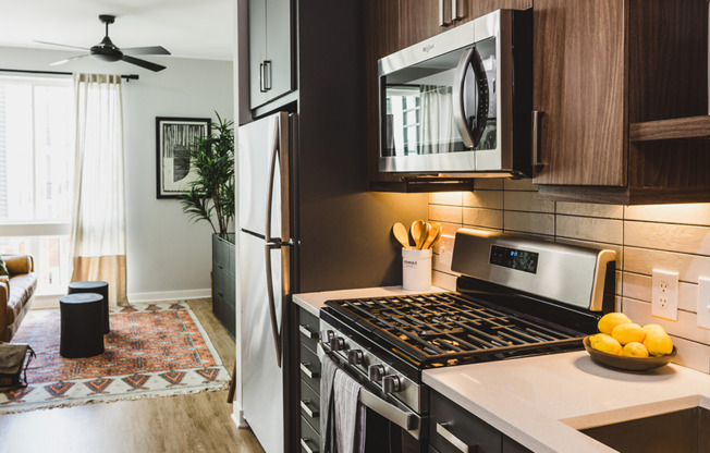 Chef-inspired galley kitchens with gas cooking, quartz counters and tile backsplash