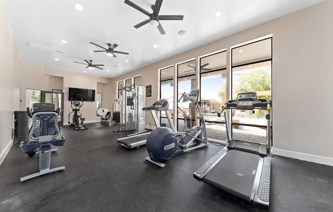 a gym with treadmills and other exercise equipment