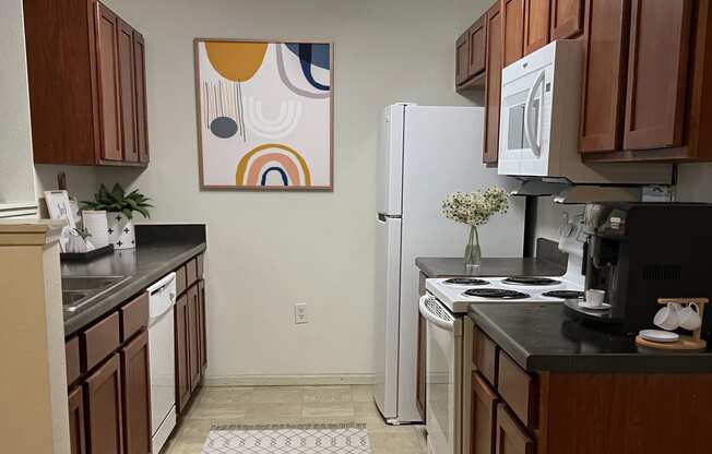 a kitchen with a white refrigerator freezer next to a stove top oven