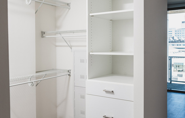 Oversized closet with custom cabinetry and drawers